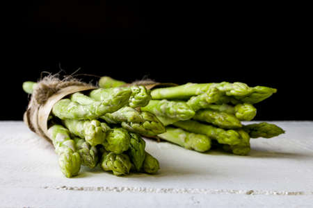Fresh green asparagus on black backgroundの写真素材