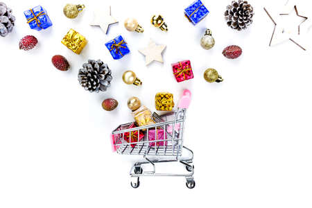 Christmas composition. Christmas gifts on cart, pine branches, toys on white background. Flat lay, top view.の写真素材
