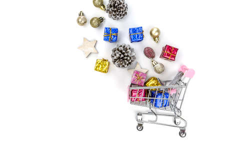 Christmas composition. Christmas gifts on cart, pine branches, toys on white background. Flat lay, top view.の写真素材
