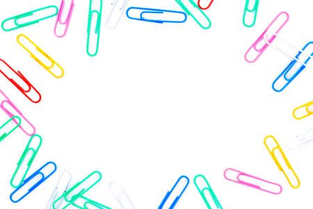 Close-up of multi-colored paper clips on a white background,Metal paper clip isolated on white,office stationery colourful frame for  backgroundの写真素材