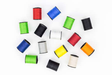 multicolored spools of thread on white background horizontal composition. Top view,Colored thread coils on white background, sewing, place for text, 
Handmade embroidery sewing background. Selective focusの写真素材