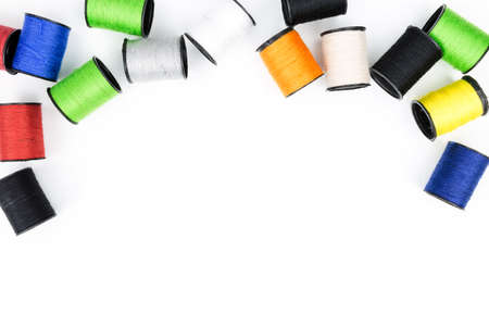 multicolored spools of thread on white background horizontal composition. Top view,Colored thread coils on white background, sewing, place for text, Handmade embroidery sewing background. Selective focusの写真素材