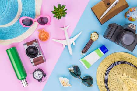Outfit and accessories of traveler on blue and pink background with copy space, Travel concept.Overhead view of Traveler's accessories, Essential vacation items, Travel concept on blue and pink background. top viewの写真素材