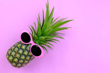 Fashion Hipster Pineapple on pink color background, Bright Summer Color, Tropical Fruit with Sunglasses, Creative Art concept. Minimal style,Hot Beach Vibes. Fun Party Moodの写真素材