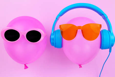 pink air balloon on pink color background, Bright Summer Color, Tropical Fruit with Sunglasses, Creative Art concept. Minimal style,Hot Beach Vibes. Fun Party Moodの写真素材