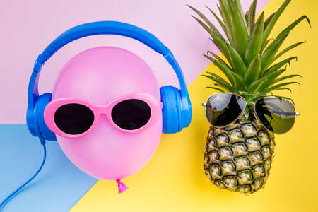 Fashion Hipster Pineapple and pink air balloon on colorful background, Bright Summer Color, Tropical Fruit with Sunglasses, Creative Art concept. Minimal style,Hot Beach Vibes. Fun Party Moodの写真素材
