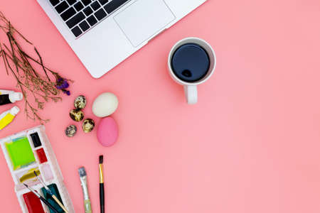 flat lay photo of modern workplace with laptop and eggs, top view laptop background and paint set...