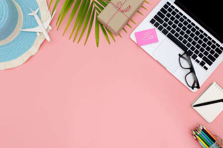 Flat lay office workspace with blank laptop, clipboard, eucalyptus branches on pink background. top view laptop background and copy space on pink background, Above view shot of laptop background, Laptop backgroundの写真素材