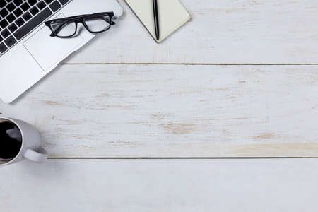 flat lay Office desk table of modern  workplace with laptop on white wooden table, top view laptop...