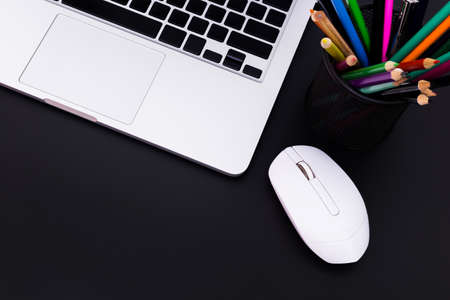 flat lay Office desk table of modern workplace with laptop on black table, top view laptop background and copy space on black background, White desk office with laptop, smartphone and other work supplies with cup of coffee.の写真素材