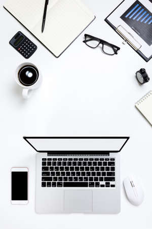 flat lay Office desk table of modern workplace with laptop on white table, top view laptop background and copy space on white background, White desk office with laptop, smartphone and other work supplies with cup of coffee.の写真素材