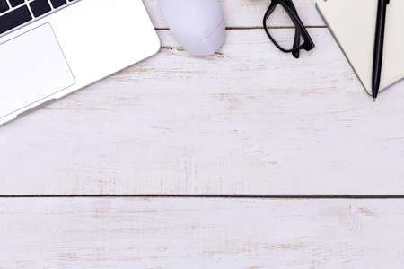 flat lay Office desk table of modern workplace with laptop on wooden table, top view laptop background and copy space on wooden background, White desk office with laptop, smartphone and other work supplies on wood desk, laptop backgroundの写真素材