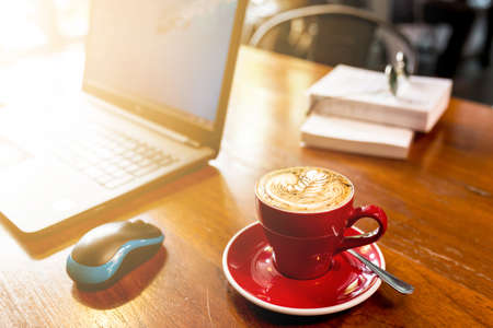 coffee on wooden desk with laptop, hot coffee with laptop background