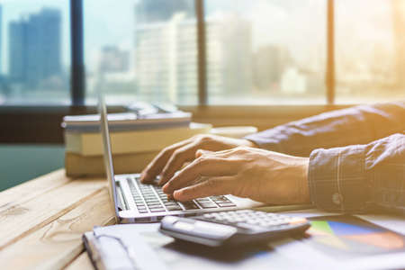 Office desk table of modern workplace with laptop on wooden table, top view laptop background and copy space on wooden background, White desk office with laptop, smartphone and other work supplies on wood desk, laptop backgroundの写真素材