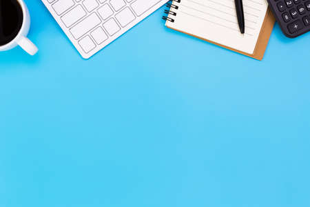 flat lay Office desk table of modern workplace with laptop on blue table, top view laptop background and copy space on black background, blue desk office with laptop, smartphone and other work supplies with mouse.の写真素材