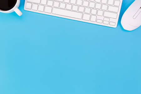 flat lay Office desk table of modern workplace with laptop on blue table, top view laptop background and copy space on black background, blue desk office with laptop, smartphone and other work supplies with mouse.の写真素材