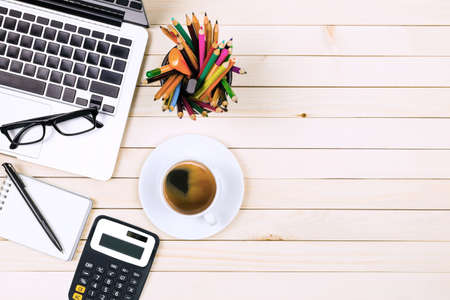 Office desk table of modern workplace with laptop on wooden table, top view laptop background and...