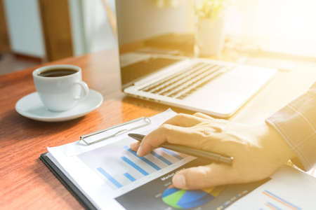 businessman working with modern workplace with laptop on wood table, Man hand on laptop keyboard for work from home, Overhead view of businessman working  in officeの写真素材