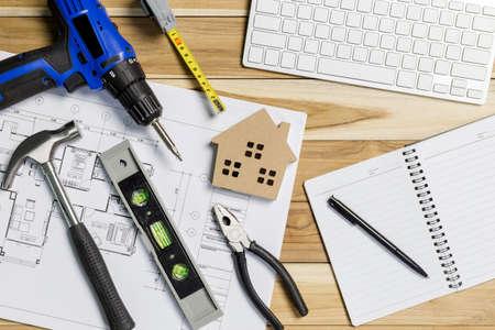 Architect workplace top view. Architectural project, blueprints, blueprint rolls on table. Construction background. Engineering tools. Copy spaceの写真素材