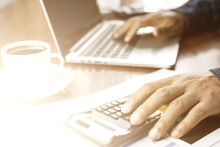 businessman working with modern workplace with laptop on wood table, Man hand on laptop keyboard for...