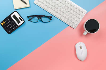 flat lay Office desk table of modern workplace with laptop on blue and pink background, top view laptop background and copy space on background, blue and pink desk office with laptop,の写真素材