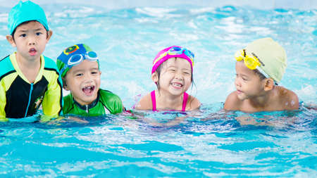 happy children kids group at swimming pool class learning to swimのeditorial素材