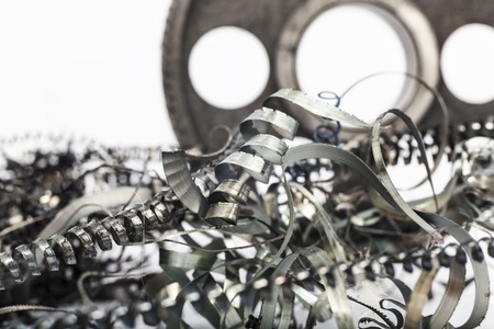 metal gear on a white background with metal filingsの写真素材