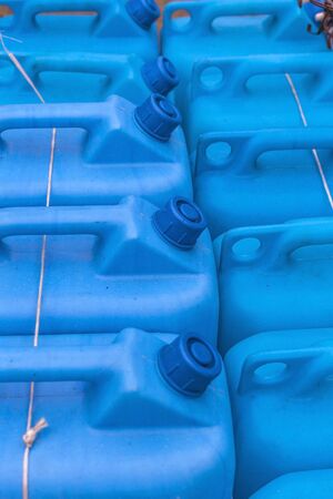 Blue plastic gas cans (fuel container) in an open market under natural lightsの写真素材