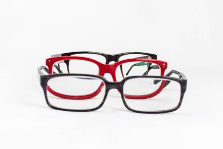 many red and black eyeglasses with white backgroundの写真素材