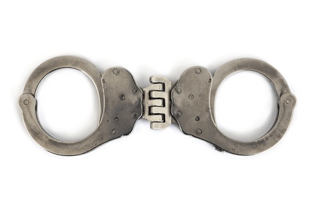 closed handcuffs with white backgroundの写真素材