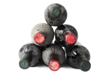 Old dusty wine bottles on white background