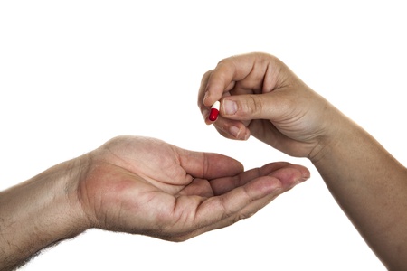 Female hand gives pill in men