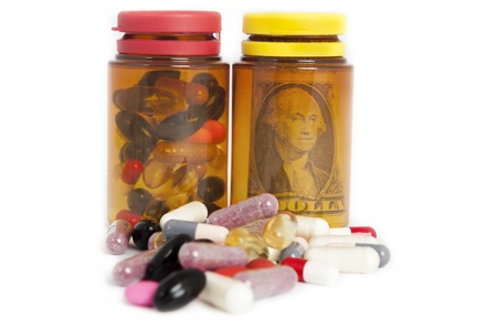 pill bottles with money and pills on white background