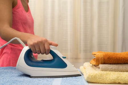 Woman ironing towelsの写真素材