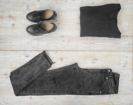 Black outfit of woman clothes on wooden backgroundの写真素材