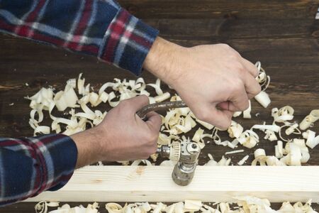 Carpenter with aged drill tool
