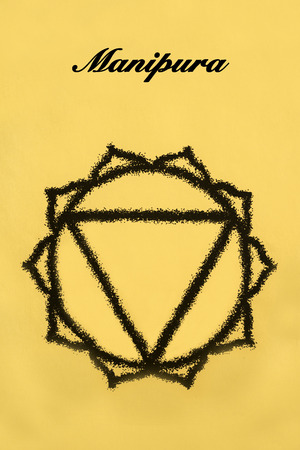 Manipura chakra.Isolated on yellow backgroundの写真素材