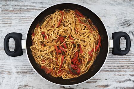 Homemade Spaghetti on pan, on wooden backgroundの写真素材