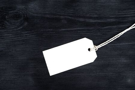 Blank tag, tied with rope on black backgroundの写真素材