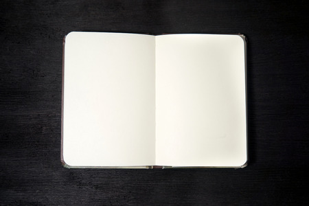 Open notebook isolated on black background