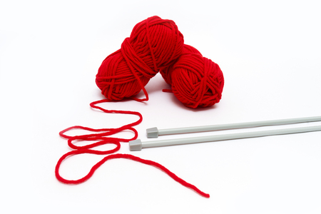 Balls of yarn with knitting needles isolated on whiteの写真素材