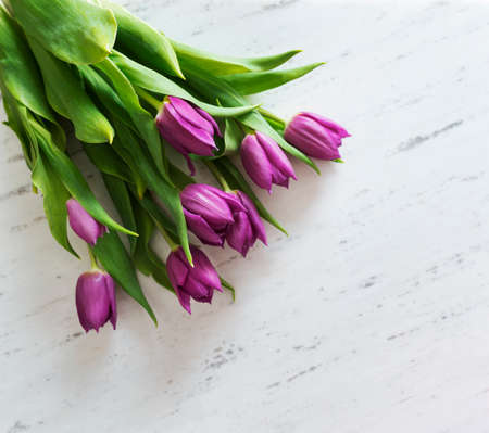 Bouquet of purple tulips on a marble background. Spring flowers.