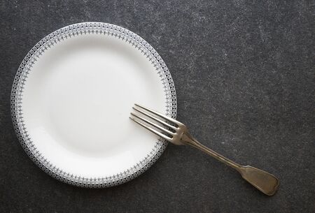 Vintage fork on black marble background