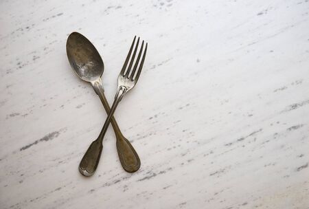 Vintage cutlery on white marble backgroundの写真素材