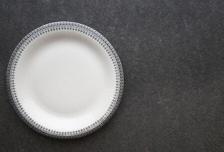 Vintage plate on black marble backgroundの写真素材