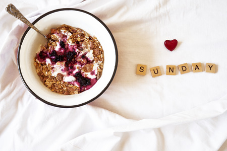 breakfast in bed and wooden letters spelling love sundayの写真素材