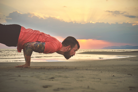 Woman practicing yoga in various poses (asana) by the seaの写真素材