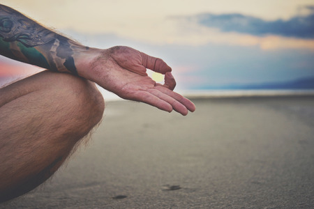 Woman practicing yoga in various poses (asana) by the seaの写真素材
