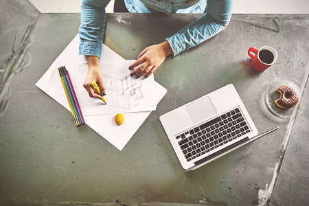 Top view of architect woman sketching a kitchen in officeの写真素材