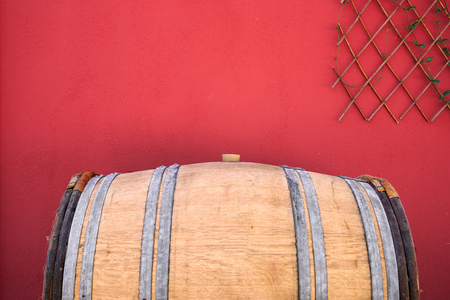 Old wooden barrel on a red background